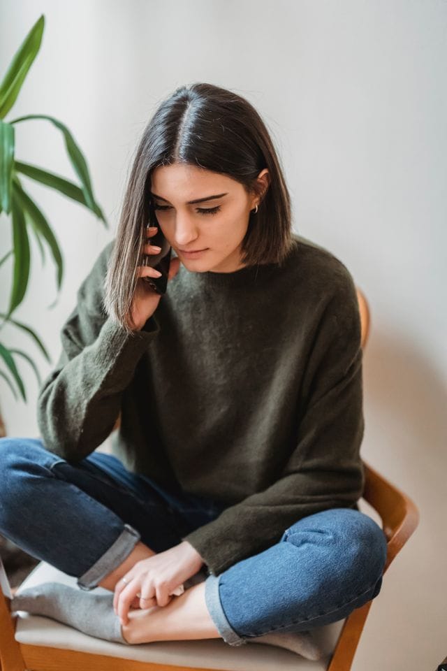 Woman talking on the phone at home